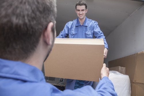 House removals team working with packed boxes and furniture in Romford