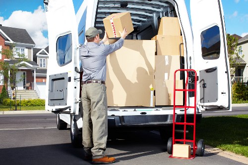 Local moving team loading boxes into a van in Romford
