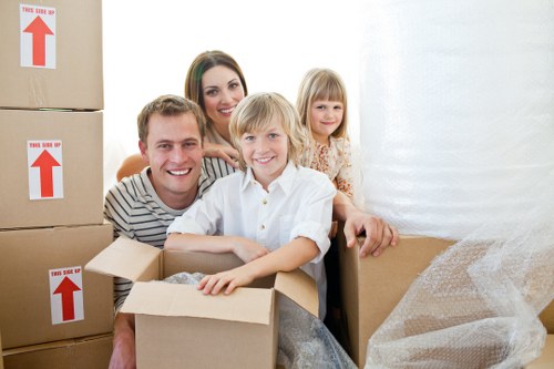 Removalists carrying furniture from a Romford family home